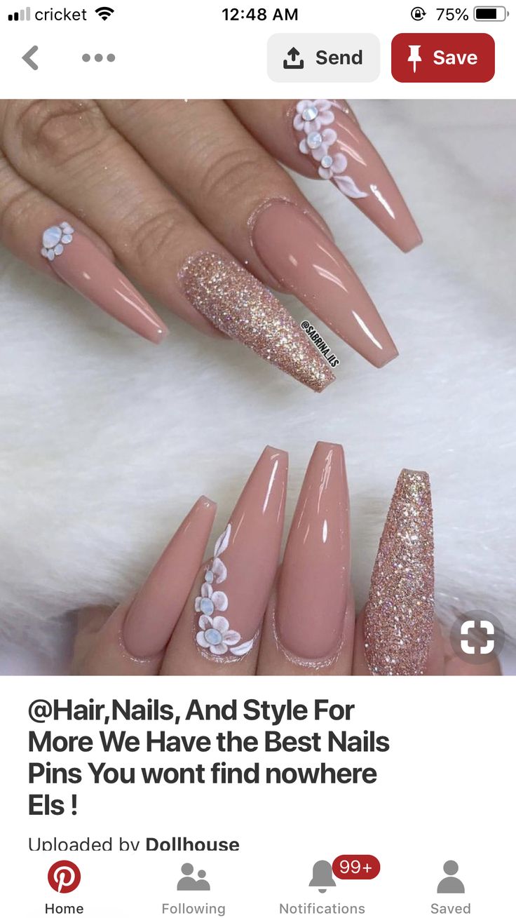 Chic Almond-Shaped Nails with Nude Base, Sparkling Accents, and Floral Embellishments.