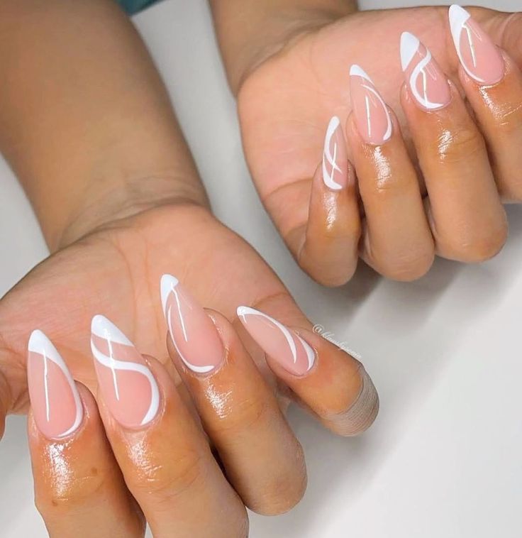 Sophisticated Almond-Shaped Nails: Nude Base with Delicate White Tips and Intricate Designs.