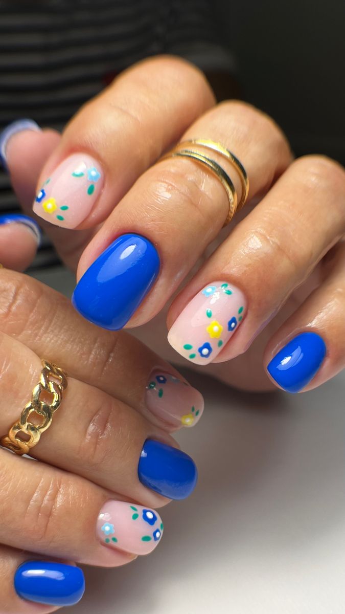 Playful Elegance: Vibrant Blue and Pastel Floral Nail Design