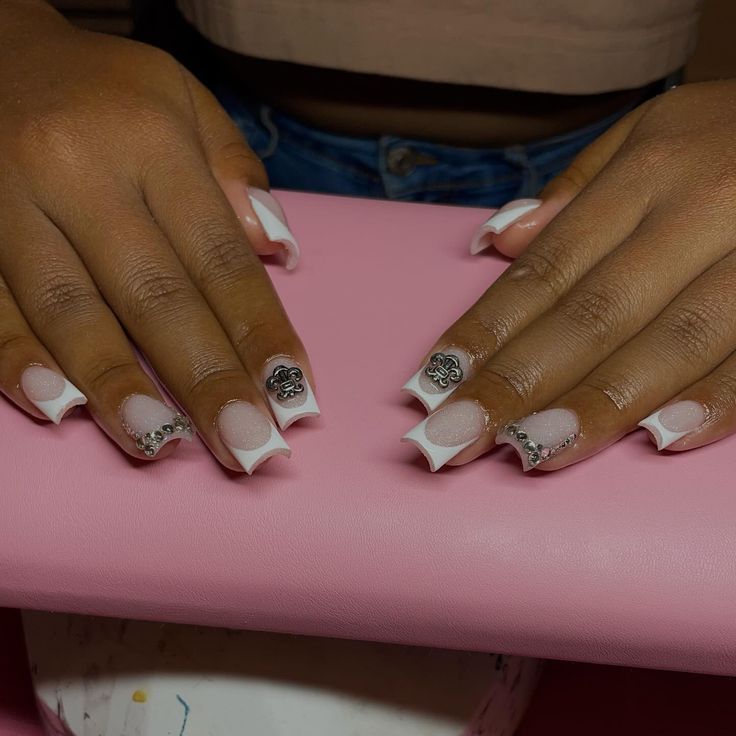 Sophisticated Nail Design: Classic French Tips Enhanced with Modern Silver Accents and Pastel Florals.