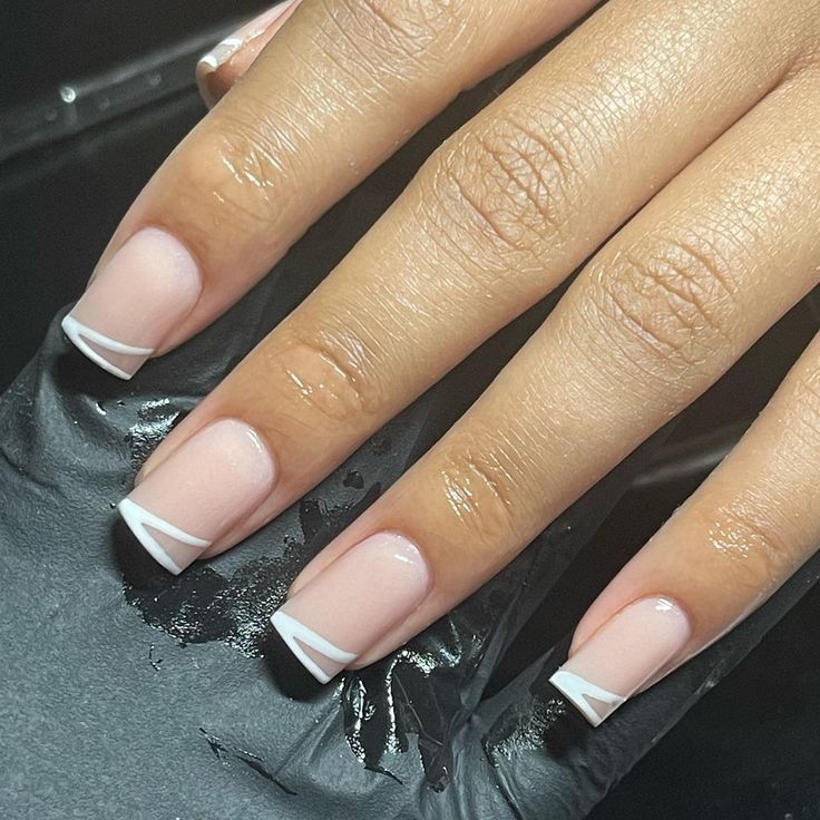 Elegant Modern Manicure: Soft Nude Base with Crisp White Tips and Geometric Accents