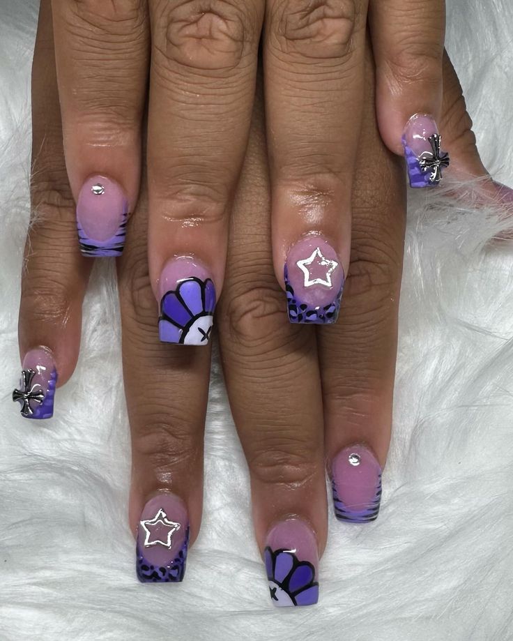 Vibrant Floral Nail Art with Purple and Pink Hues Showcasing Chic Accents and Trendy Gradient Technique.