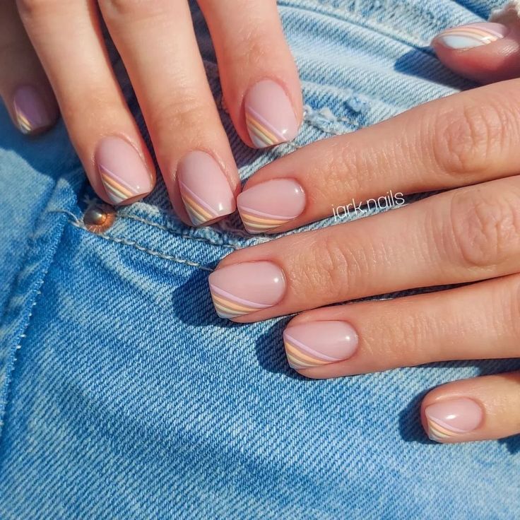 Chic Nude Nail Design with Pastel Stripes and Geometric Tips