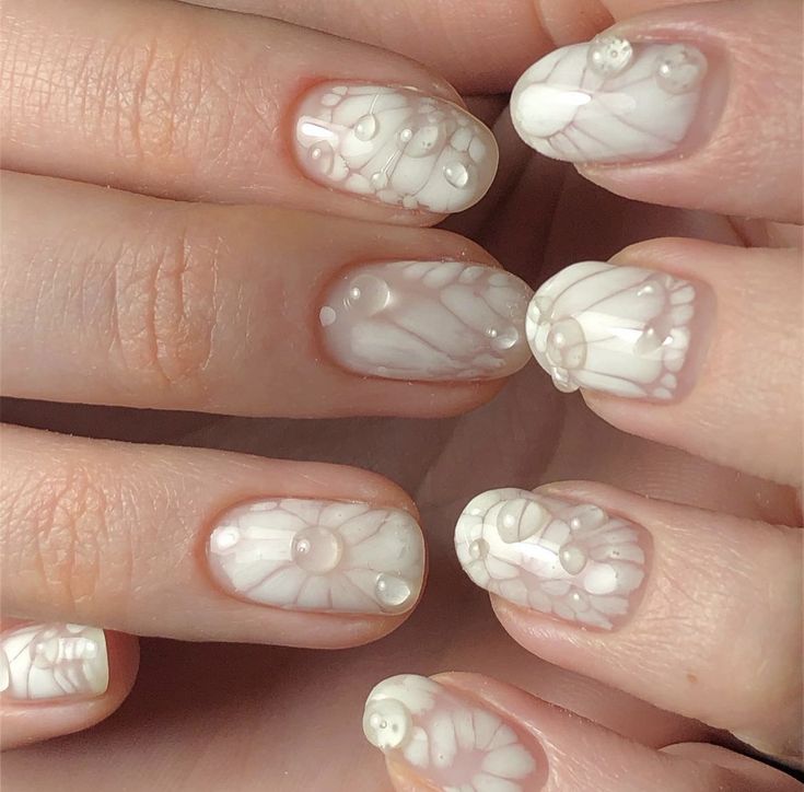 Elegant Swirling White Nail Design with Raised 3D Patterns