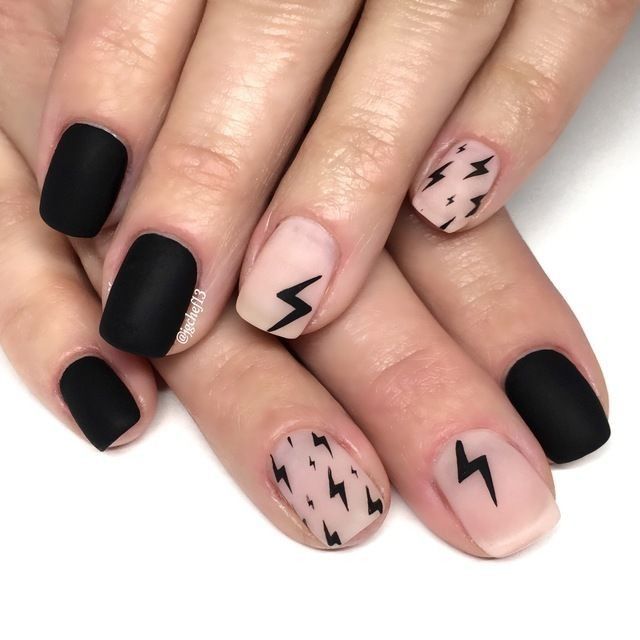 Edgy Matte Black and Nude Nail Design with Dynamic Lightning Bolt Motifs.