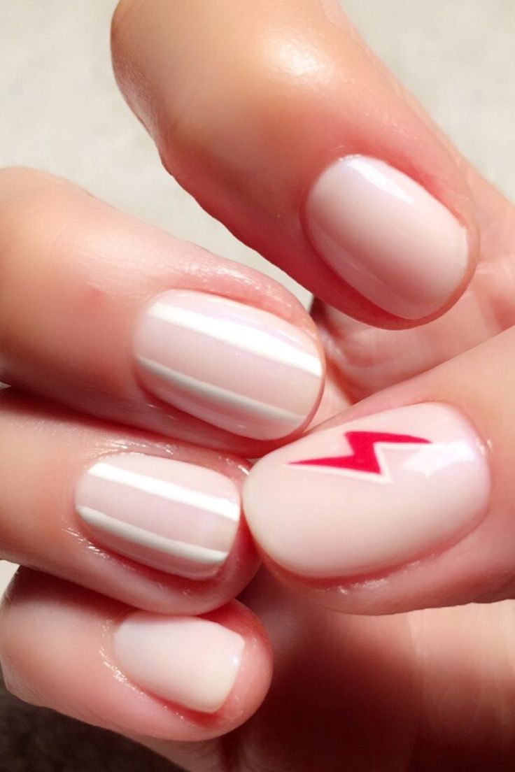 Chic Nude Nail Design with White Stripes and Bold Red Lightning Bolt Accent.