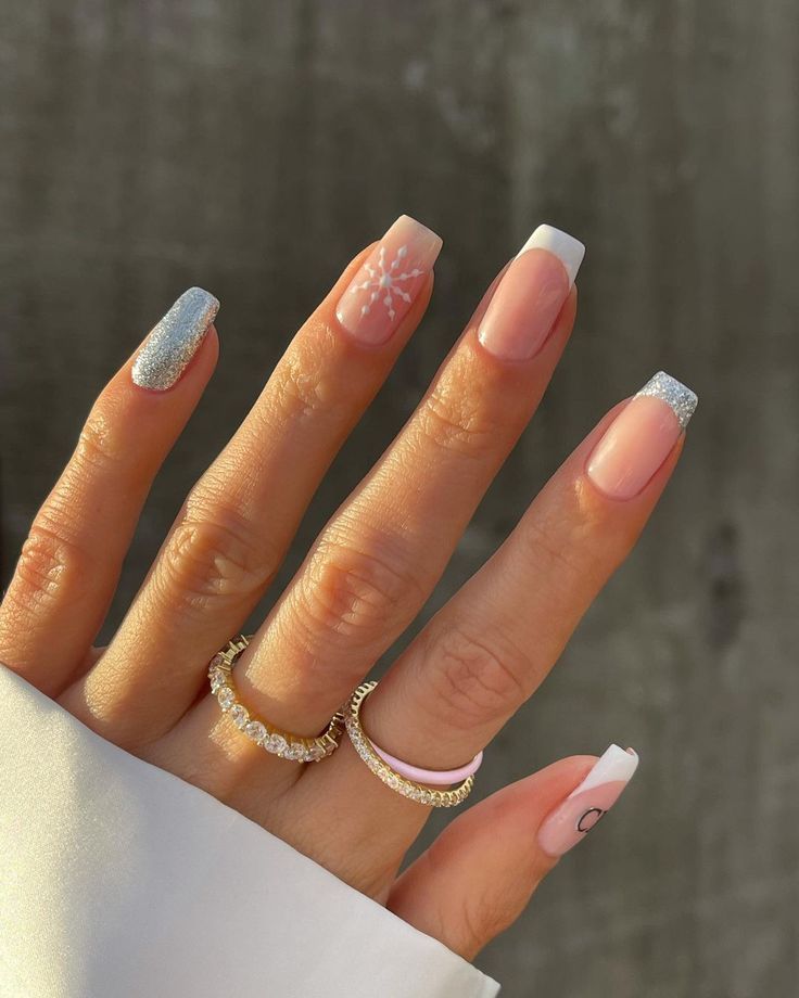 Sophisticated Nail Design with Soft Pink, Shimmering Silver, and Floral Accents.