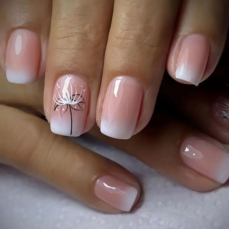 Elegant Ombre Nails: Soft Pink to Creamy White with Delicate Floral Design for Versatile Style.