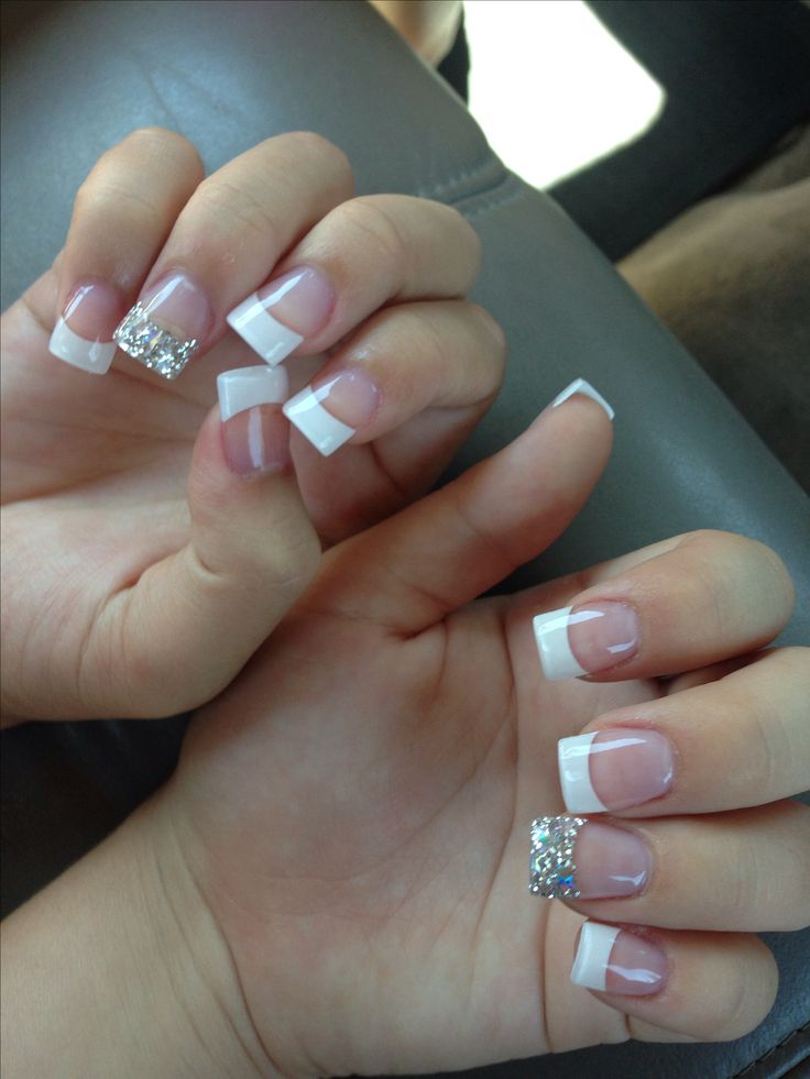 Chic French Tip Nails with Sparkling Rhinestone Accents.