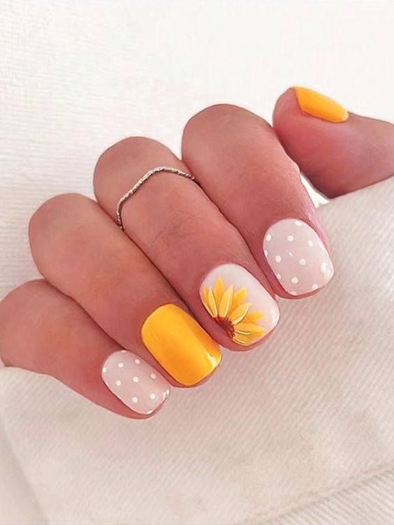 Cheerful Sunny Nail Design with Polka Dots and Sunflower Accent.