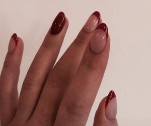 Chic Red and Nude Nail Design with Pointed Tips and Half-Moon Detail.