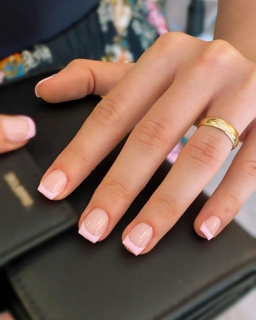 Timeless Elegance: Classic French Tip Nail Design with Subtle Nude Base and Gold Accents