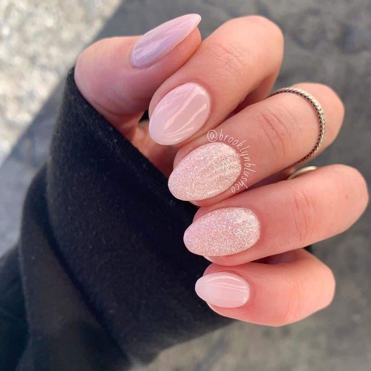 Elegant Soft Pink Nail Design with Glossy Finishes and Shimmering Accents.