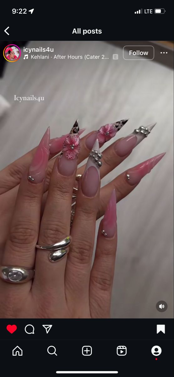 Sophisticated Stiletto Nail Design with Floral Accents and Pastel Hues.