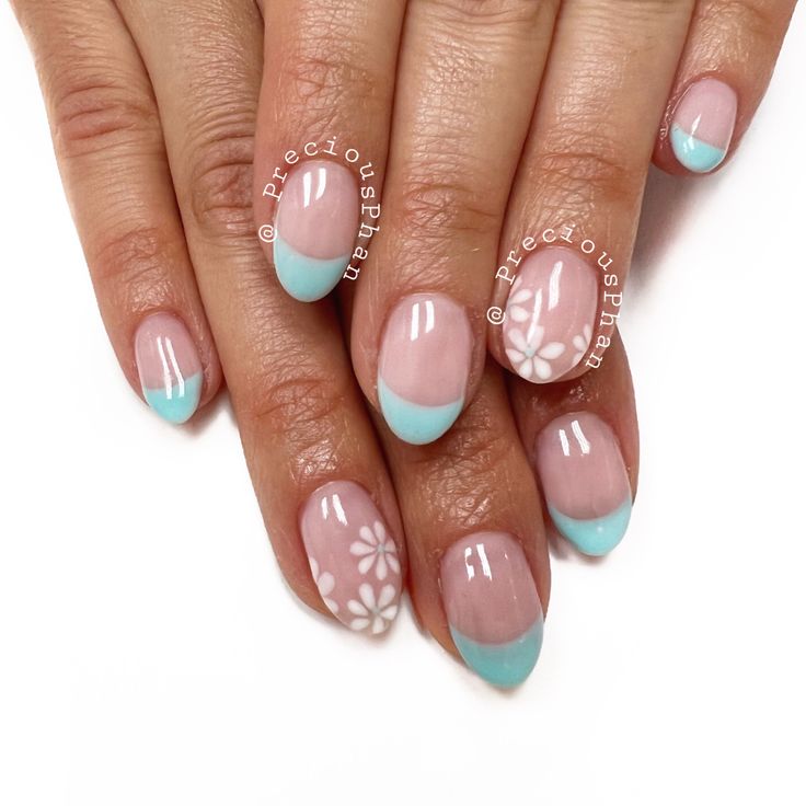 Elegant Floral-Themed Nail Design: Pastel Blue French Tips with Delicate White Accents for a Fresh Spring Look.