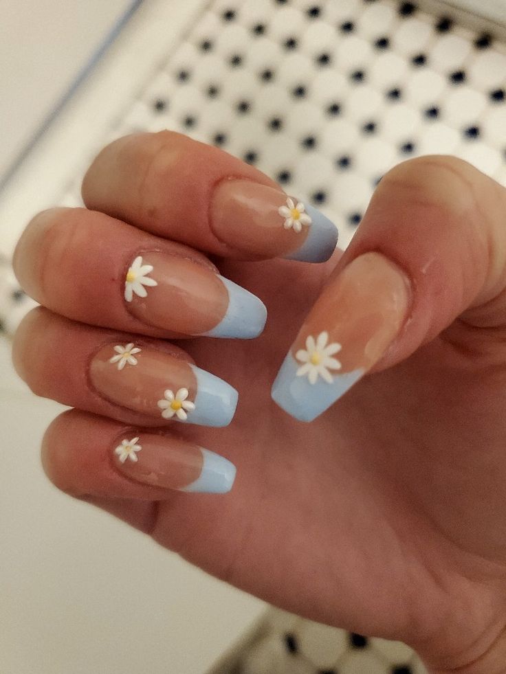 Charming Floral Nail Design with Soft Blue Ombre Tips and Dainty Daisies for a Springtime Vibe.