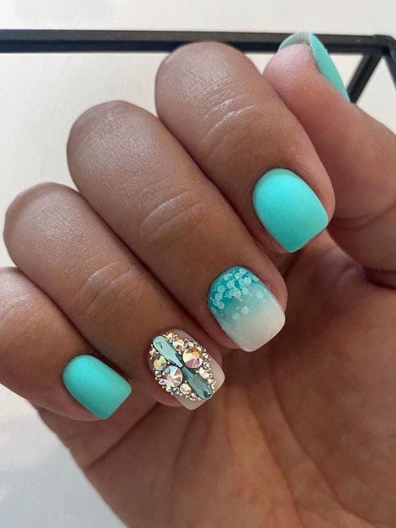 Trendy Vibrant Mint Green Matte Nails with Gradient Accent and Floral Rhinestone Design.