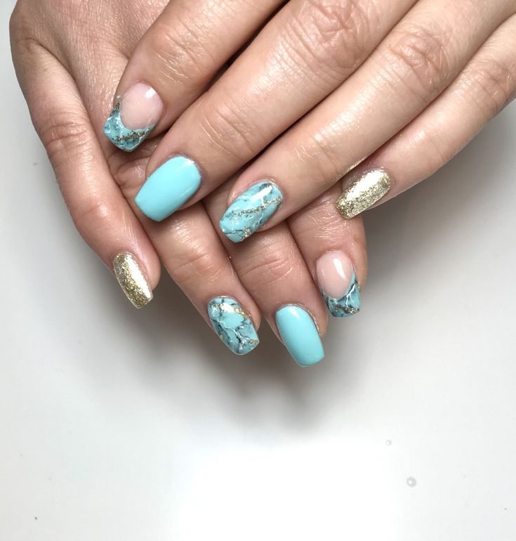 Elegant Colorful Nail Design: Light Blue, Shimmering Gold, and Artistic Marbling with Nude Accents.