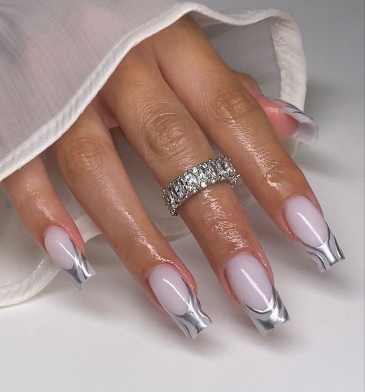 Elegant Nail Design: Soft Pink Base with Sleek Silver Tips and Glossy-Matte Contrast.