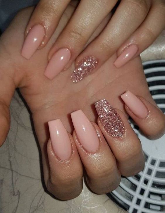 Chic Elegant Nail Design: Soft Pink Base with Glitter Accent for Glamorous Occasions.