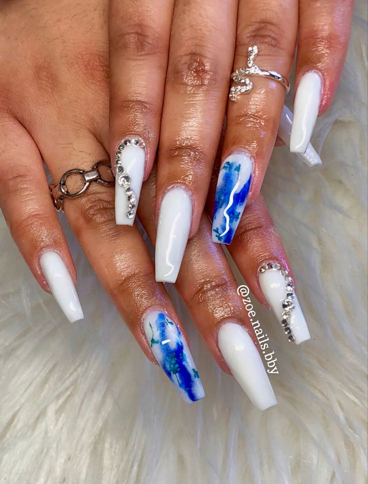 Chic White and Watercolor Blue Nail Design with Rhinestone Accents.