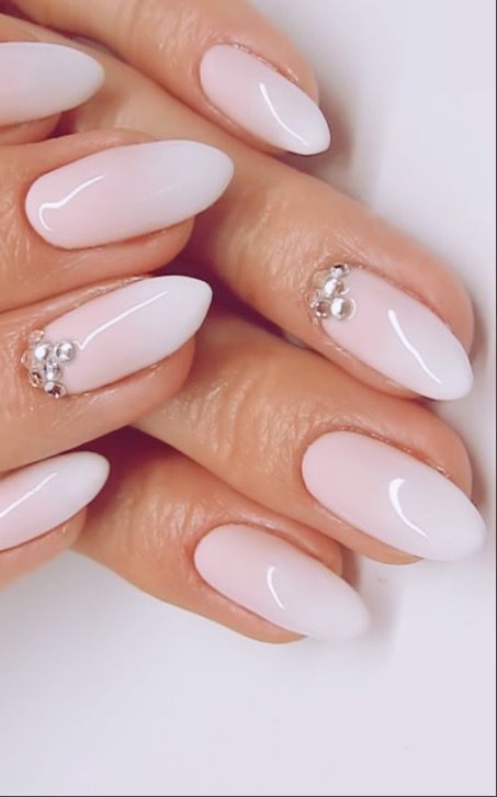 Refined Almond-Shaped Ombre Nails with Subtle Tips and Glamorous Embellishments