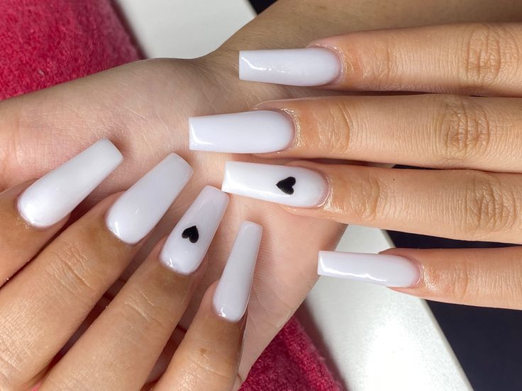 Chic Elegant White Nail Design with Playful Black Heart Accents