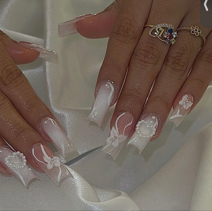 Sophisticated Elegant Nail Design with Floral Details, Pearls, and Ribbons on Long Acrylics.