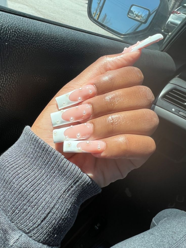 Sophisticated Nail Design with Clear and White Tips, Soft Pink Base, and Pearl Accents