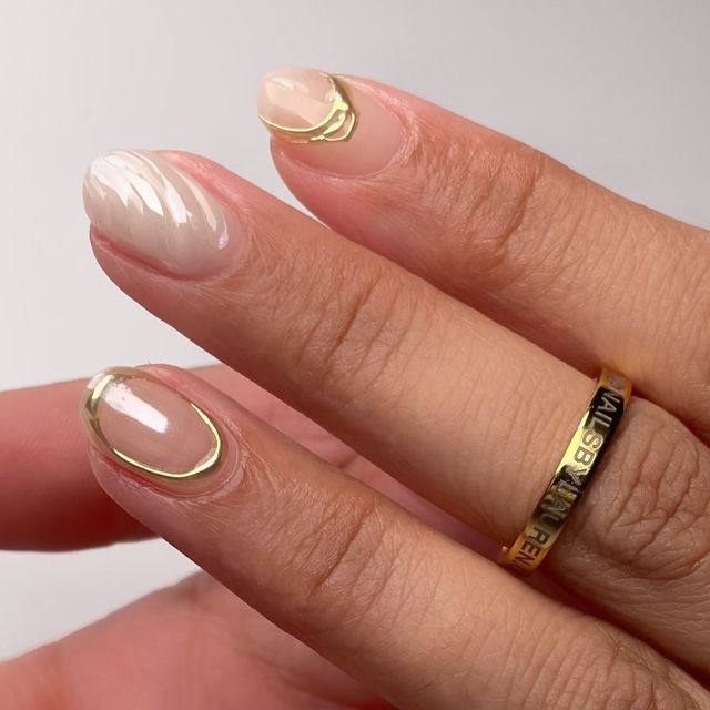 Sophisticated Nude and Glossy Nail Design with Delicate Gold Accents.