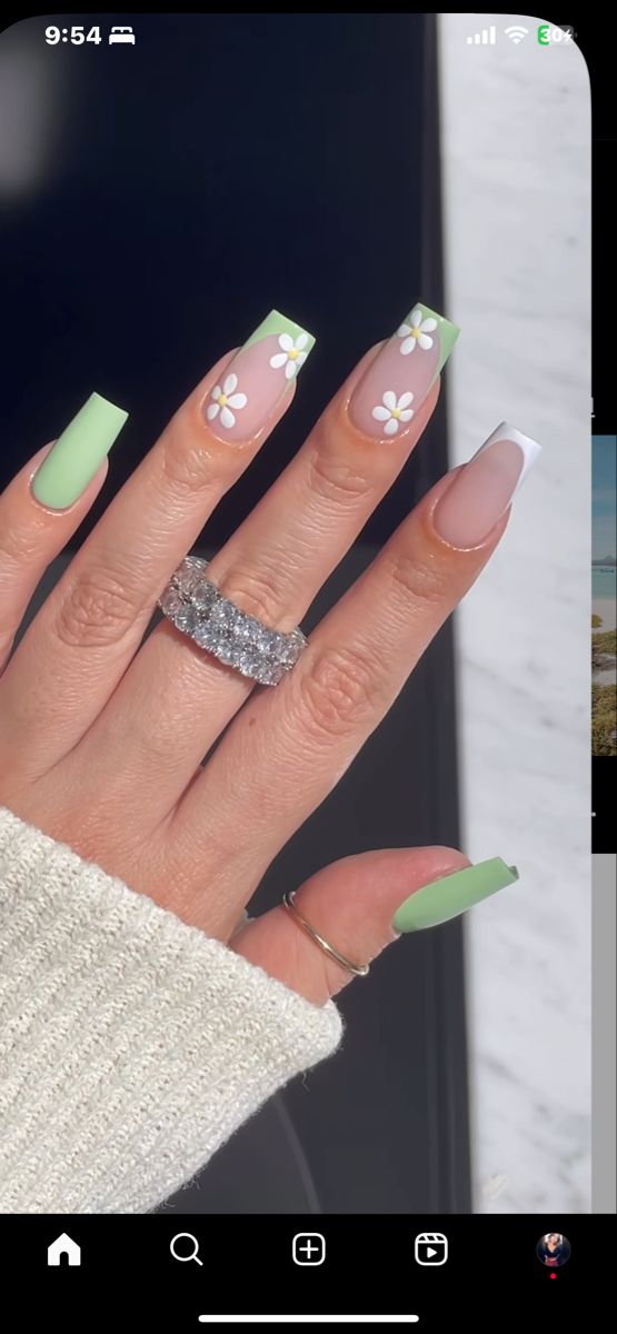 Trendy Pastel Green and Nude Nail Design with White Daisy Accents