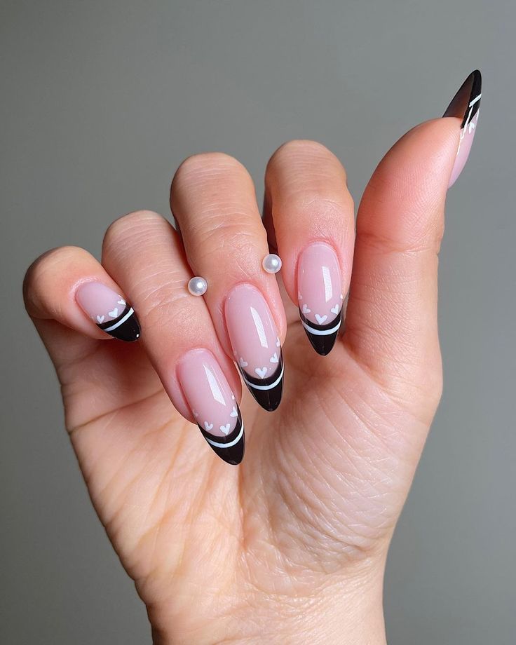 Chic French Tip Nail Design with Black Tips, Nude Base, and Pearl Accents for Any Occasion.