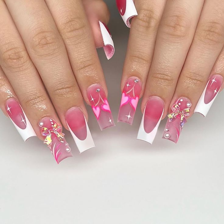 Playful Pink Ombre Nails with Heart Designs and Elegant White Tips for Romantic Charm.