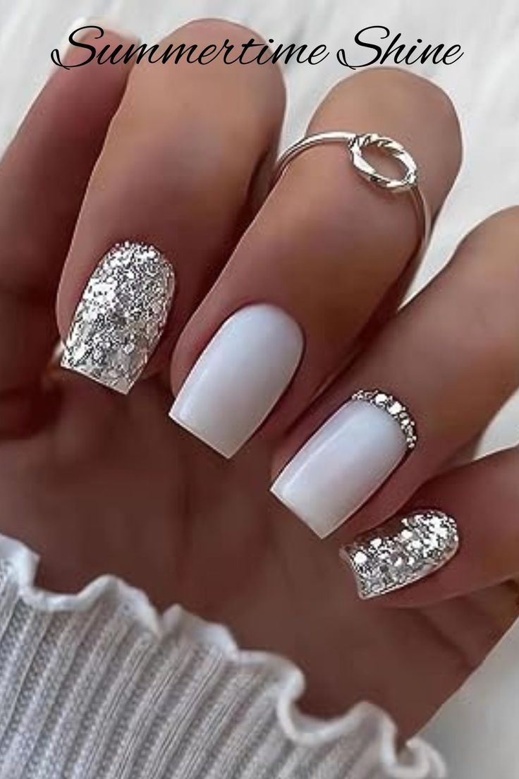 Chic Summer Nail Design: Crisp White Base with Shimmering Silver Accents.