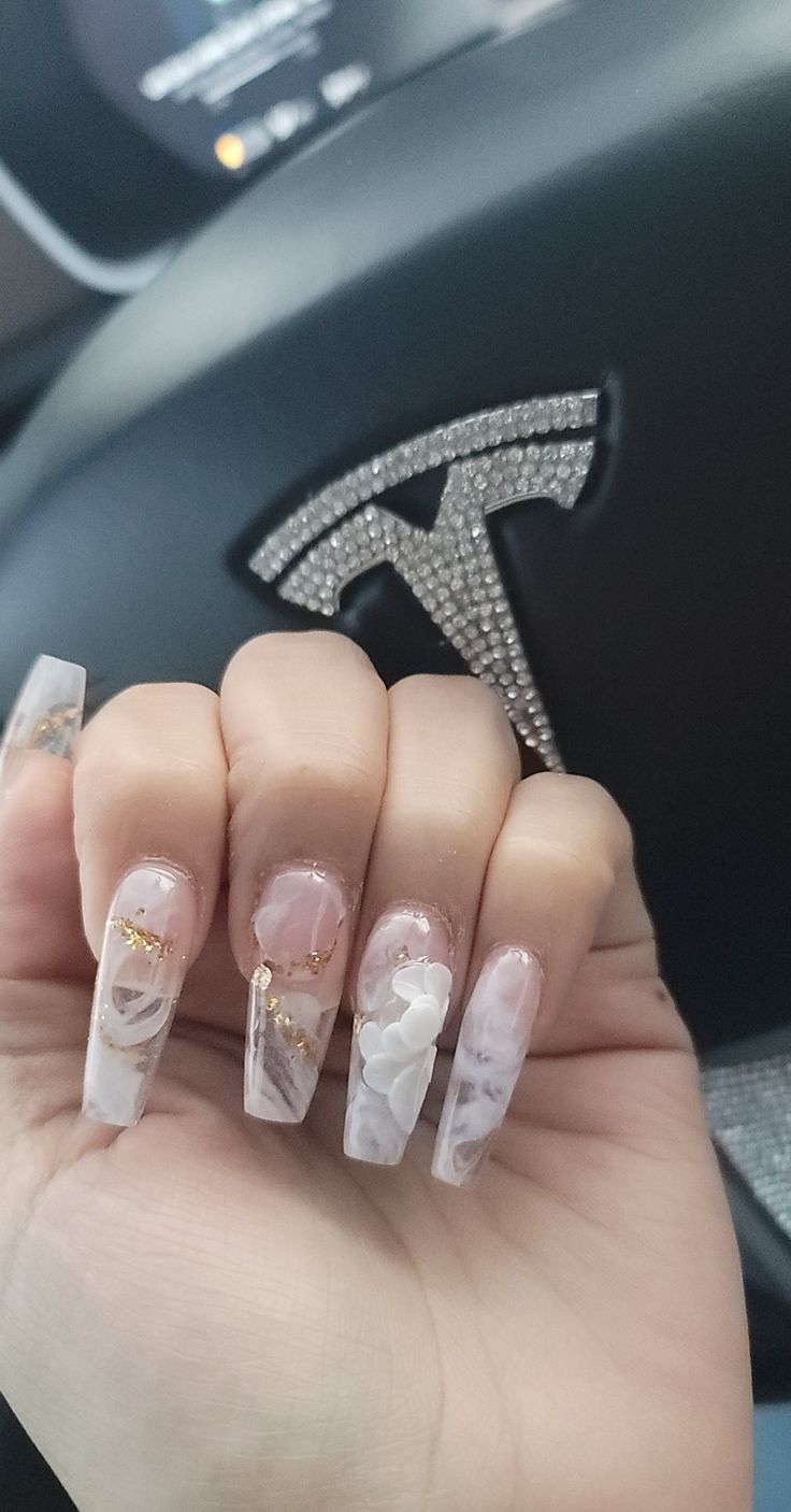 Sophisticated White and Translucent Marble Nail Design with Gold Accents and Floral Embellishments.