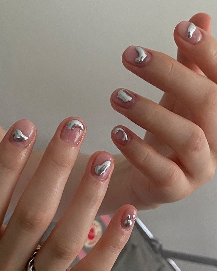 Chic Nude Nail Design with Elegant Silver Metallic Swirls and Mixed Finishes