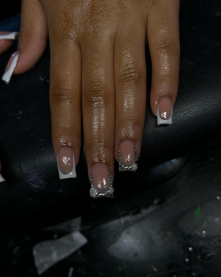 Sophisticated French Manicure with Elegant Silver Accents and Gemstones on Long Square Tips.