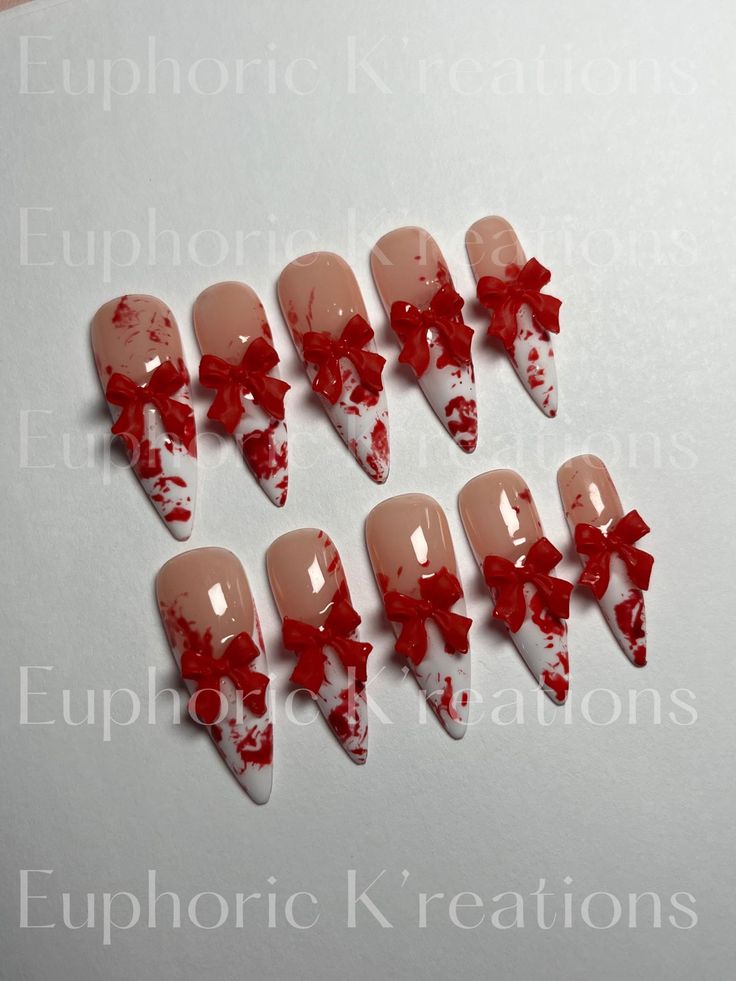 Chic Almond-Shaped Nail Design with Nude and White Shades, Adorned with Playful Red Bows and Festive Gradient Effects.