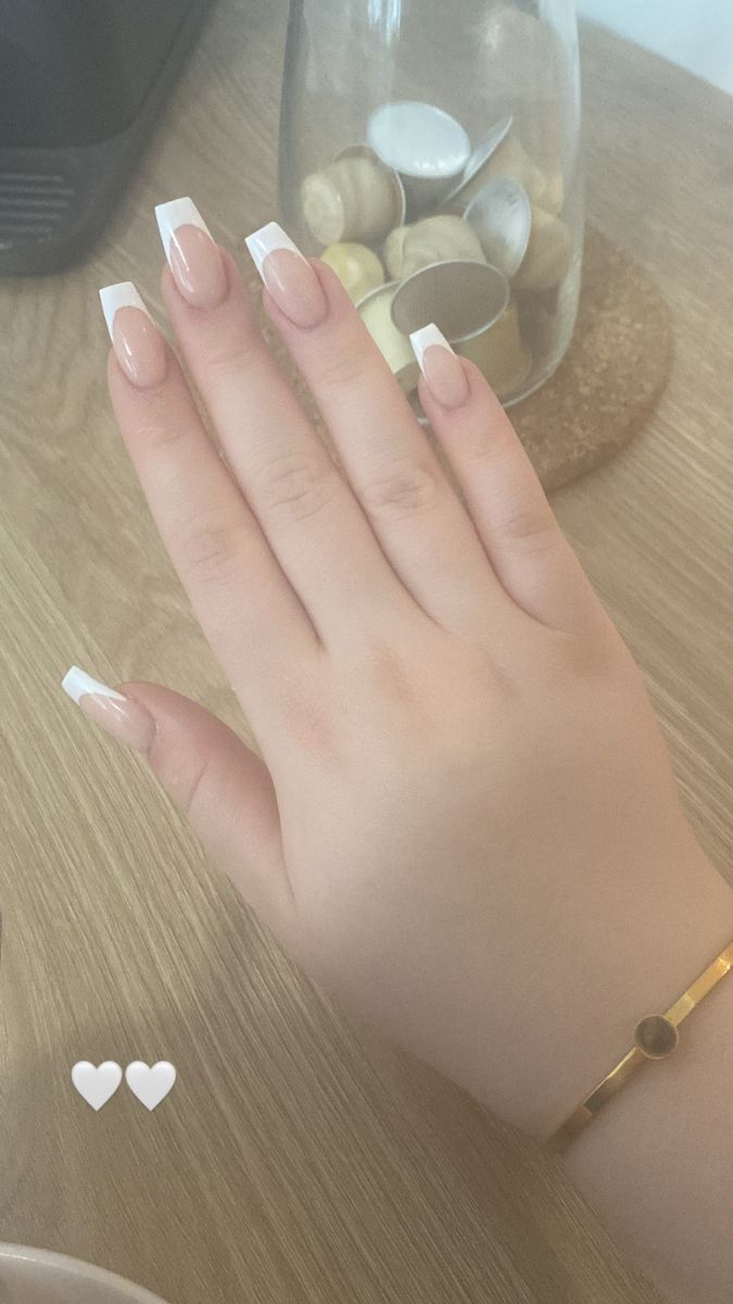 Elegant French Tip Nails with Delicate Gold Bracelet: Timeless Beauty Redefined.