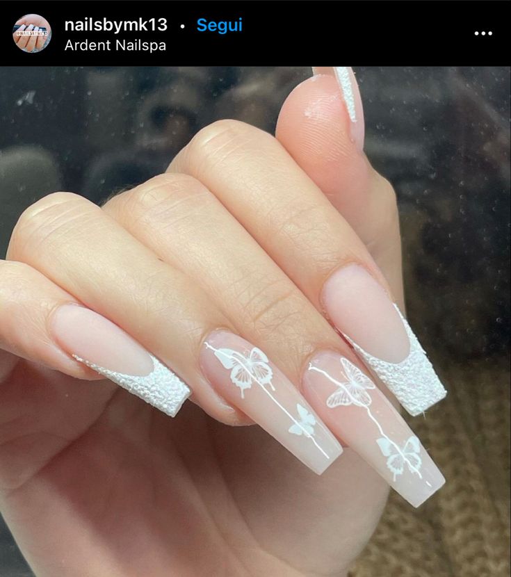 Chic French Tip Nail Design with Nude Shades and Intricate White Butterflies