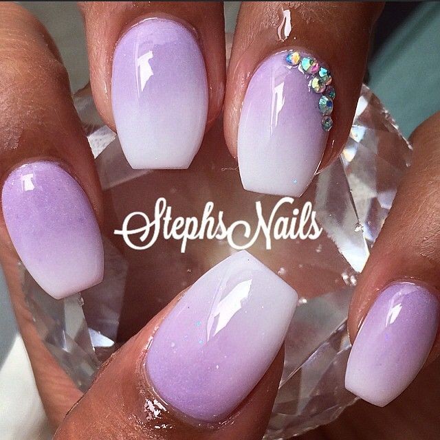 Chic Ombre Lavender and White Nail Design with Glamorous Rhinestone Accents.