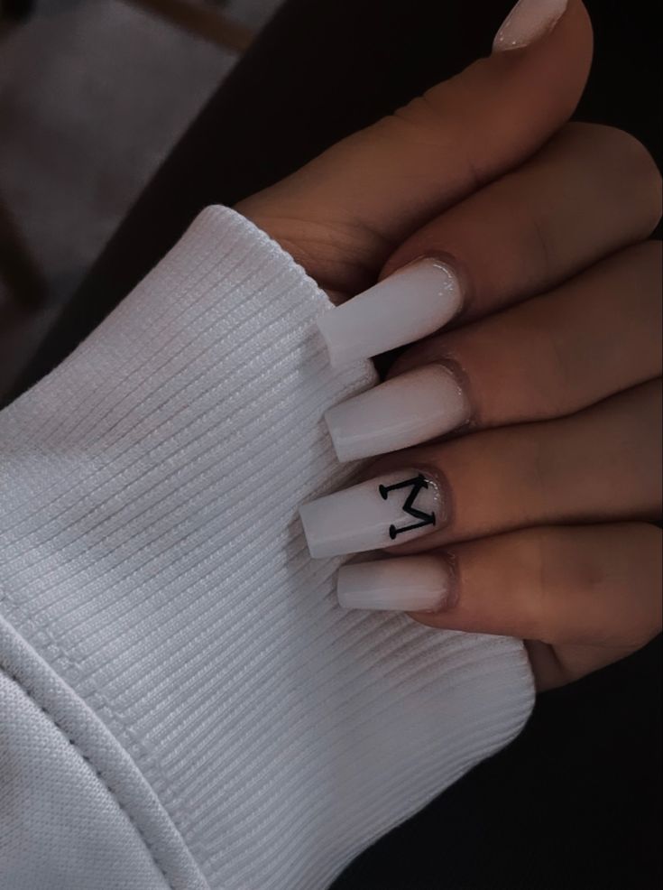 Sophisticated Long White Acrylic Nails with Bold Black Detailing for a Modern Minimalist Look.