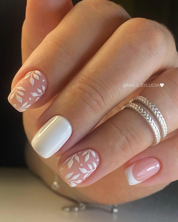 Elegant Soft Pink and White Nail Design with Leaf Patterns and Mixed Finishes.