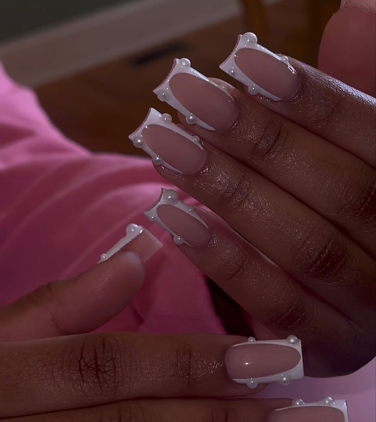 Elegant Chic Nail Design with Soft Pink, White Tips, and Pearls.