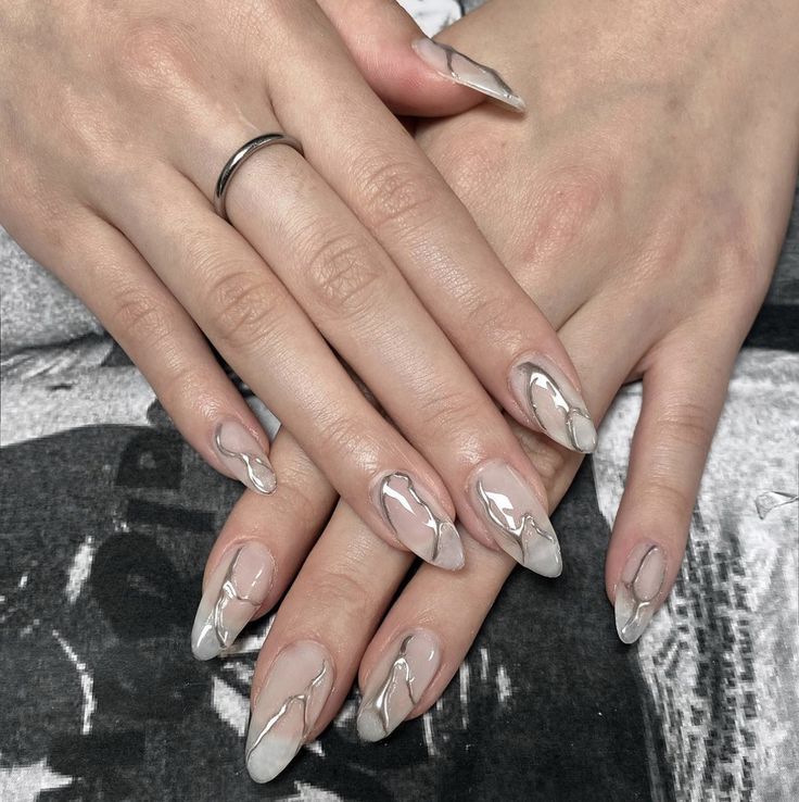 Sophisticated Elegant Nude Nails with Glossy Finish and Artistic Marble Accents