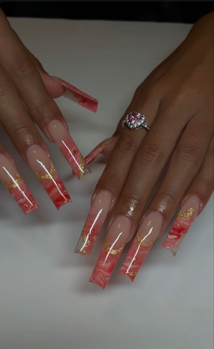 Elegant Long Acrylic Nails with Soft Pink and Vibrant Red Marbling and Gold Accents.