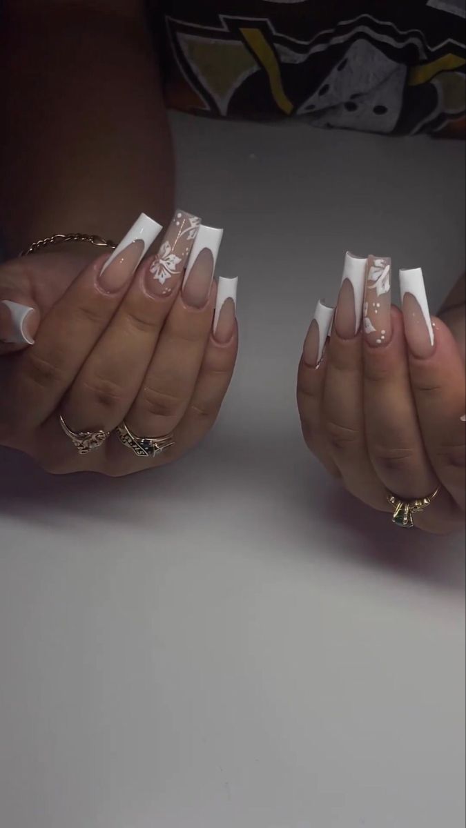 Chic French Manicure with Elegant Floral Accents on Long Squared Tips.