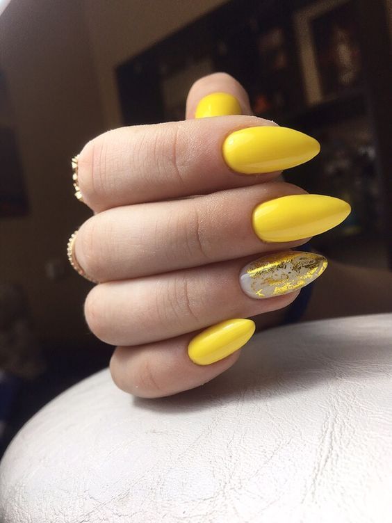 Bold and Cheerful Yellow Almond-Shaped Nails with Glossy Gold Flake Accent.