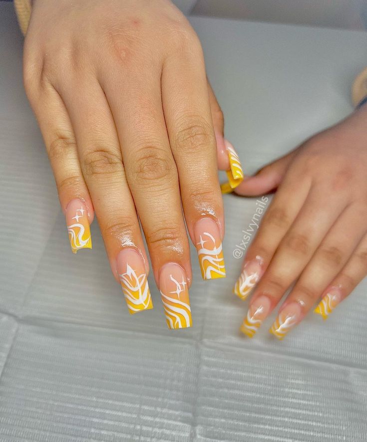 Cheerful Playful Elegance: Vibrant Yellow and White Nail Design with Swirls and Geometric Patterns.