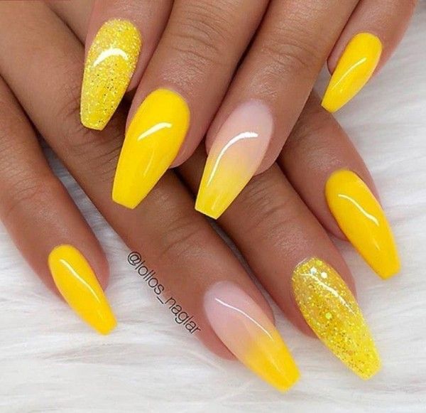 Cheerful Yellow Nail Design with Glossy Finishes and Glitter Accents for a Playful Look.